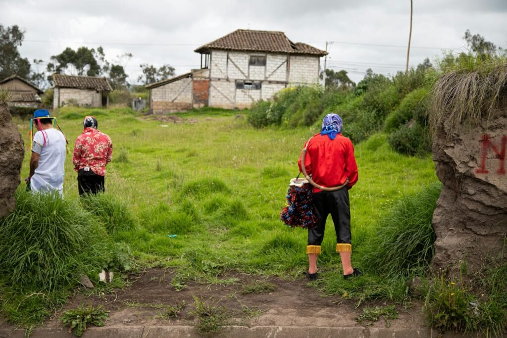 People Standing on Grass in Village