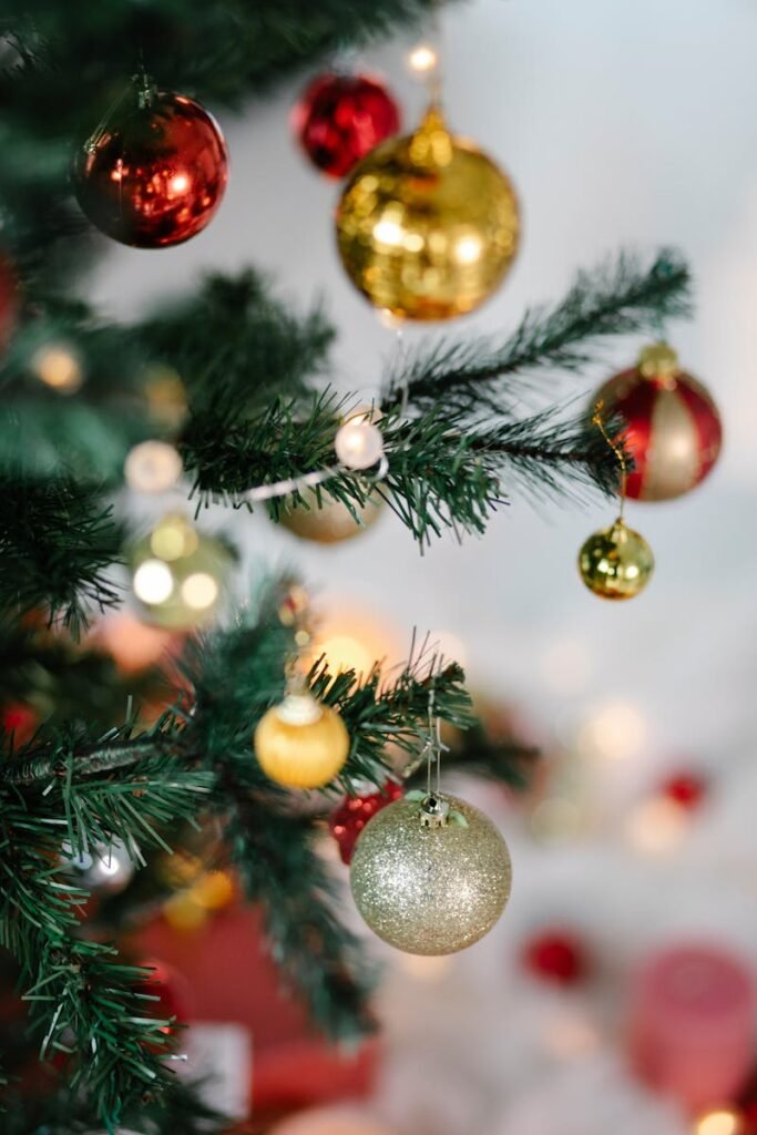 Christmas tree with red and golden baubles and glowing lights